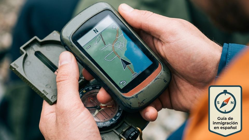 SouthToNorth.com hero: hands holding a GPS and compass, with the South to North Spanish immigration guide badge